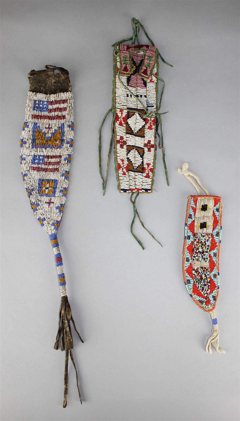 Appraisal: NATIVE AMERICAN BEADED HIDE BELT CASES TWO KNIFE CASES Provenance