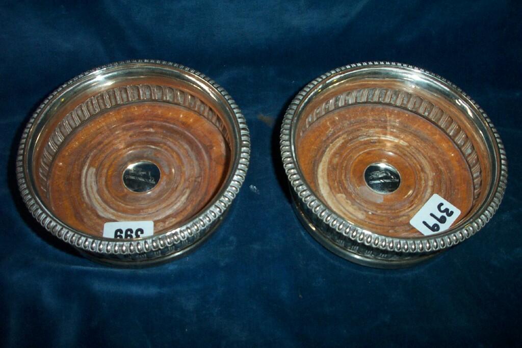 Appraisal: A pair of Georgian silver coasters with turned wood bases