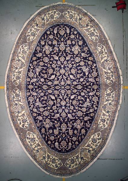 Appraisal: An oval Nain carpet size approximately ft in x ft