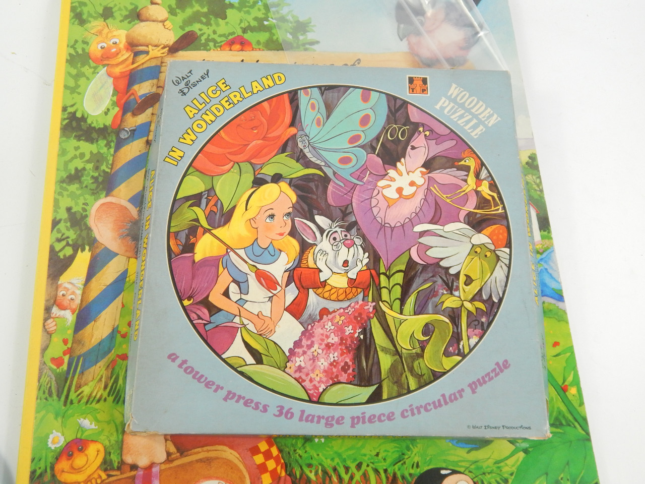 Appraisal: A Walt Disney Alice in Wonderland circular wooden puzzle of