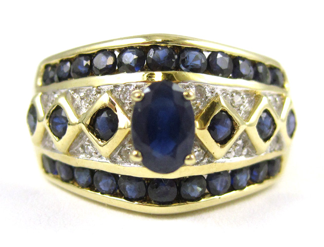 Appraisal: SAPPHIRE DIAMOND AND FOURTEEN KARAT GOLD RING centering an oval-cut