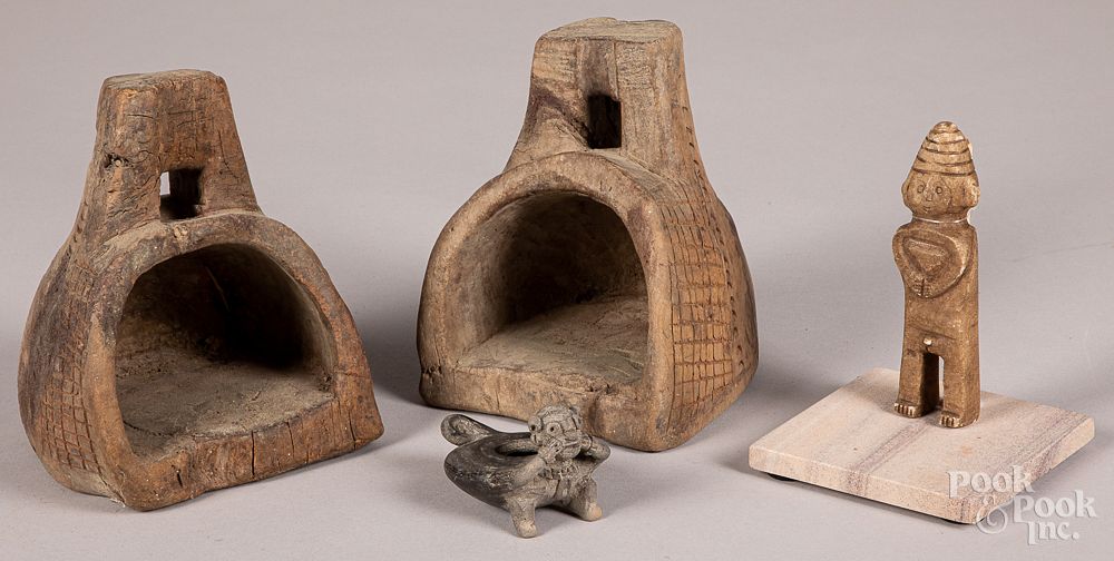 Appraisal: Two Peruvian post-conquest stirrups with carved Two Peruvian post-conquest stirrups