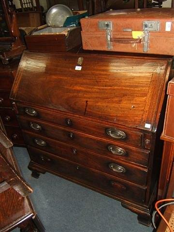 Appraisal: A George III mahogany bureau the fitted interior with serpentine