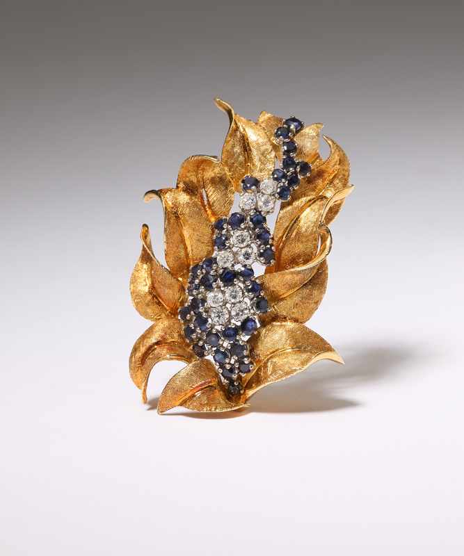 Appraisal: A diamond and sapphire foliate brooch Tested K gold set