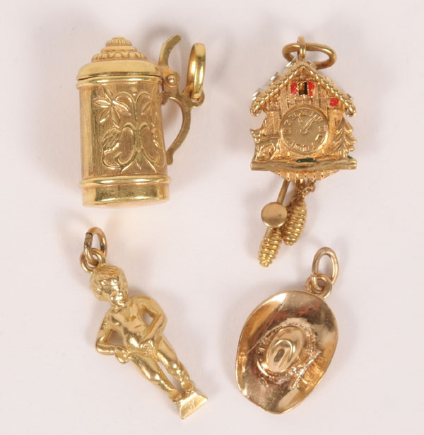 Appraisal: Lot of four gold charms child figure of Brussels Mannekin