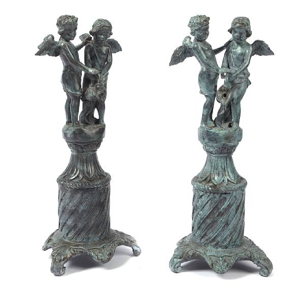 Appraisal: A pair of patinated bronze figures of two cherubs on