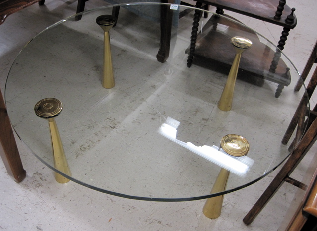 Appraisal: MODERN GLASS AND BRASS COFFEE TABLE having a round glass