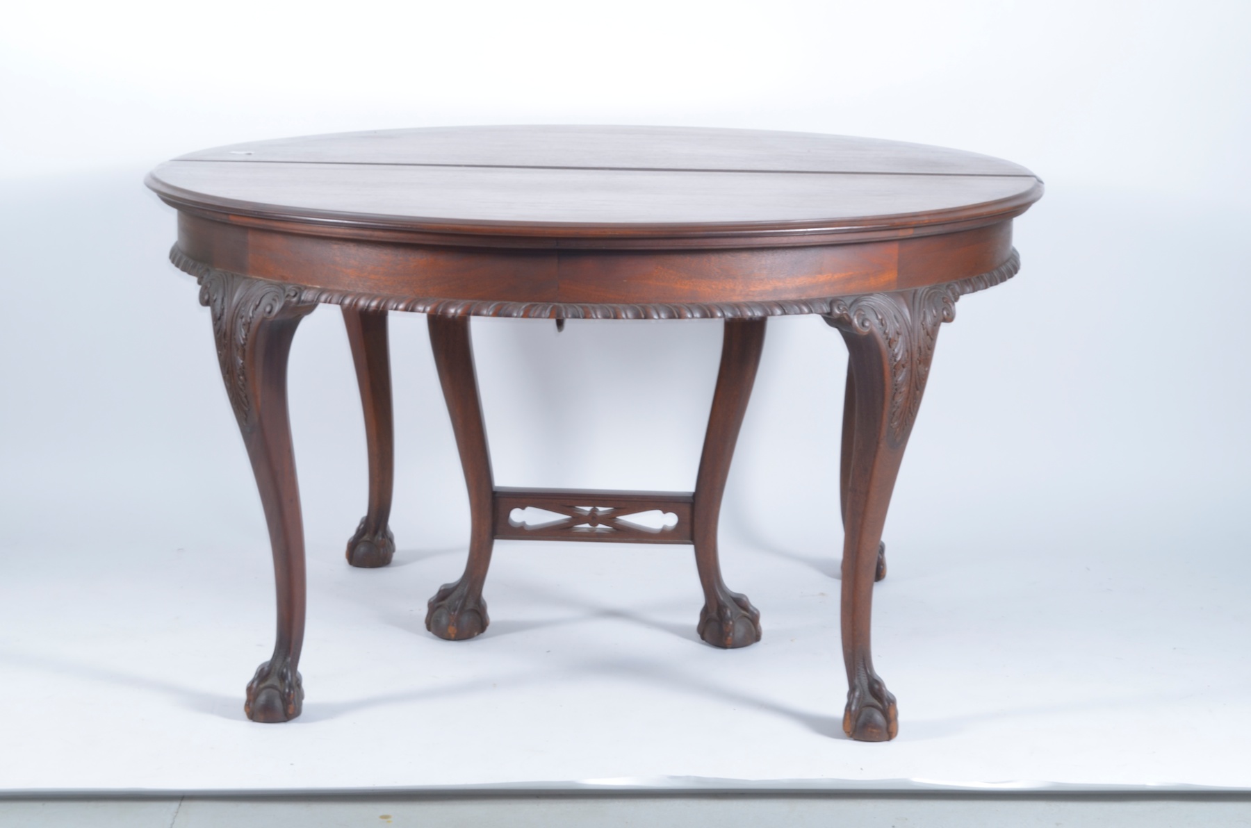 Appraisal: MAHOGANY DINING TABLE with claw ball feet Diameter with three