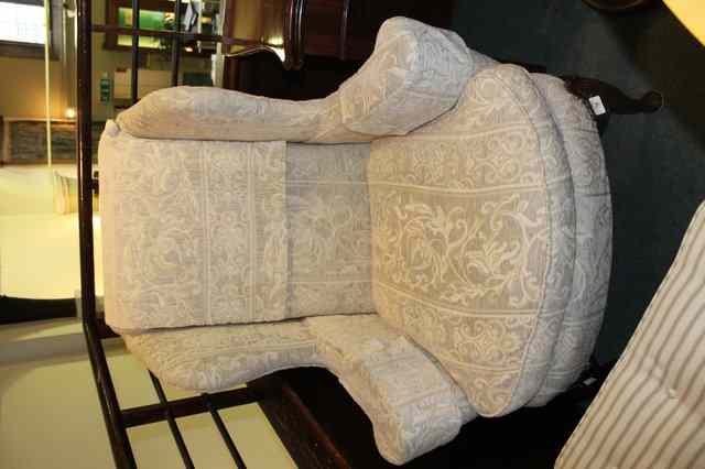 Appraisal: A GEORGIAN STYLE WING ARMCHAIR on carved mahogany supports