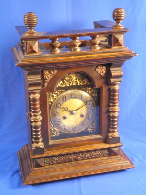 Appraisal: A German walnut mantel clock with an arched brass dial