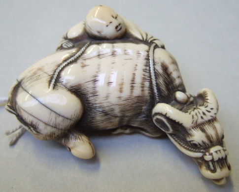 Appraisal: An ivory netsuke of a recumbent ox th century carved