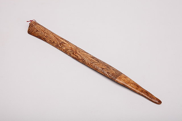 Appraisal: A CASSOWARY BONE DAGGER with stylised carved decoration and tapering