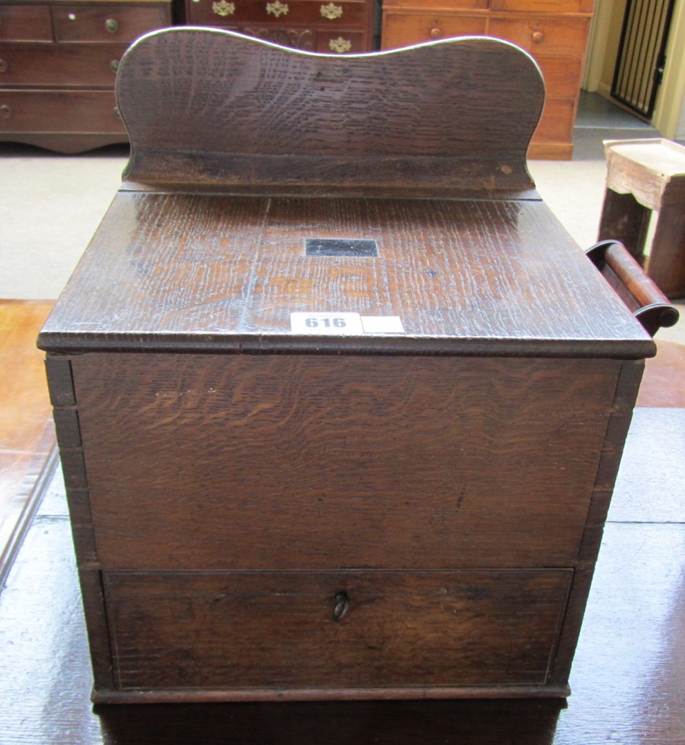 Appraisal: An oak ballot box with lift top over single lower