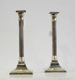 Appraisal: A pair of silver plated candlesticks in the shape of