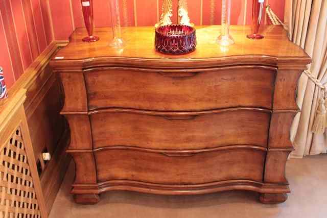 Appraisal: A SATIN BIRCH SERPENTINE FRONTED THREE DRAWER COMMODE with shaped