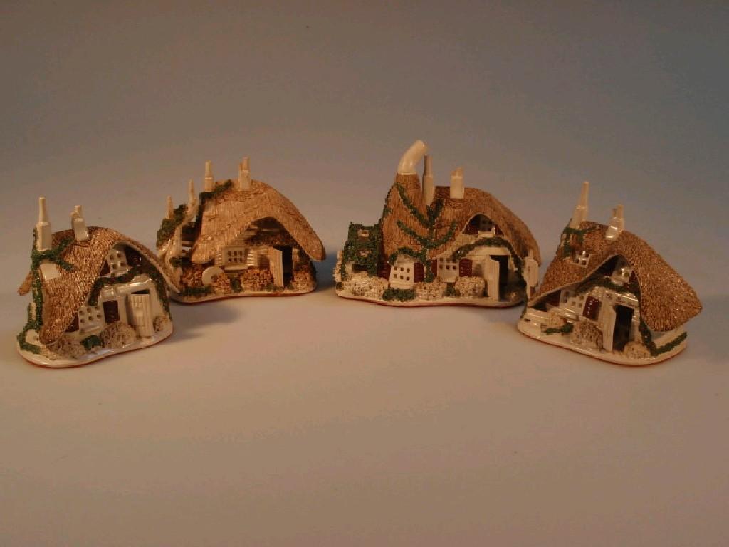 Appraisal: Four Canziani pottery thatched cottages