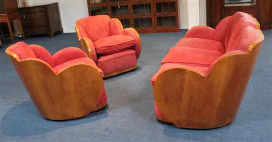 Appraisal: An Art Deco walnut three piece cloud back suite upholstered