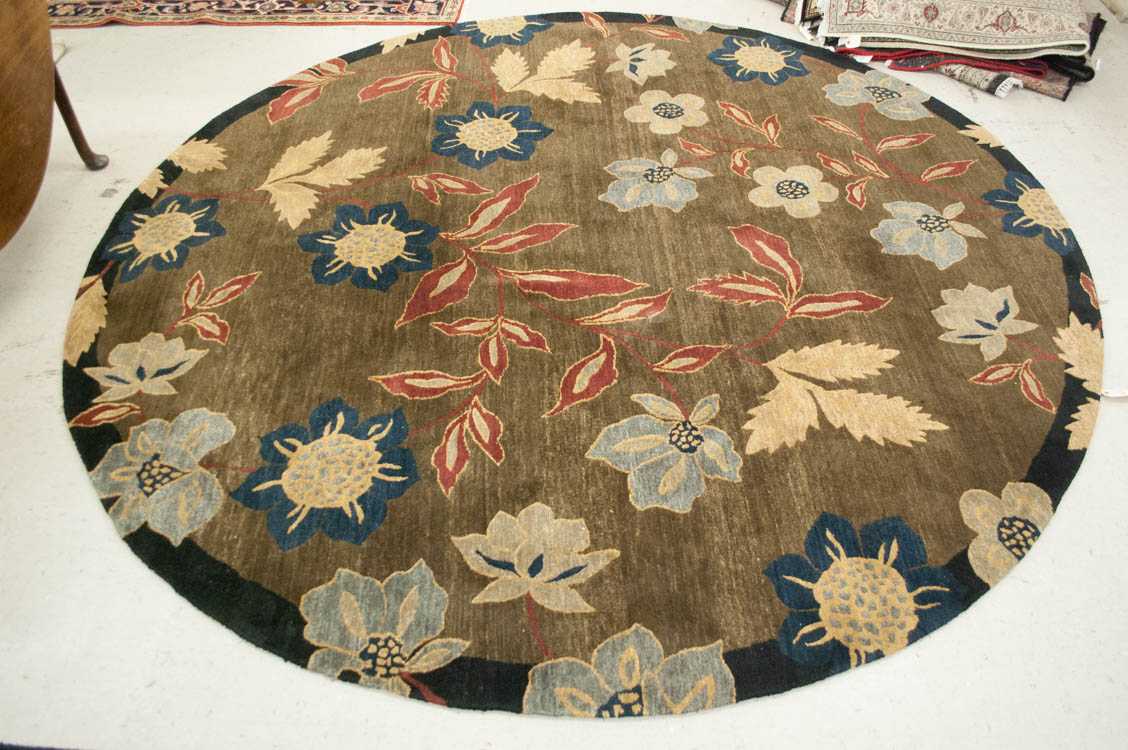 Appraisal: ROUND TIBETAN CARPET Tufenkian Artisan label floral pattern on brown