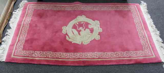 Appraisal: A Chinese rug sewn with dragon on pink ground cm