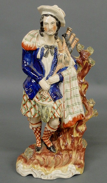 Appraisal: Colorful Staffordshire Scottish bagpiper c h x w