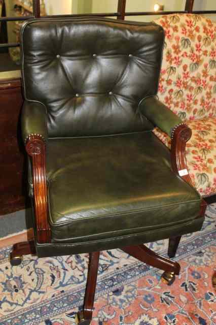 Appraisal: A MAHOGANY AND LEATHER REVOLVING DESK CHAIR