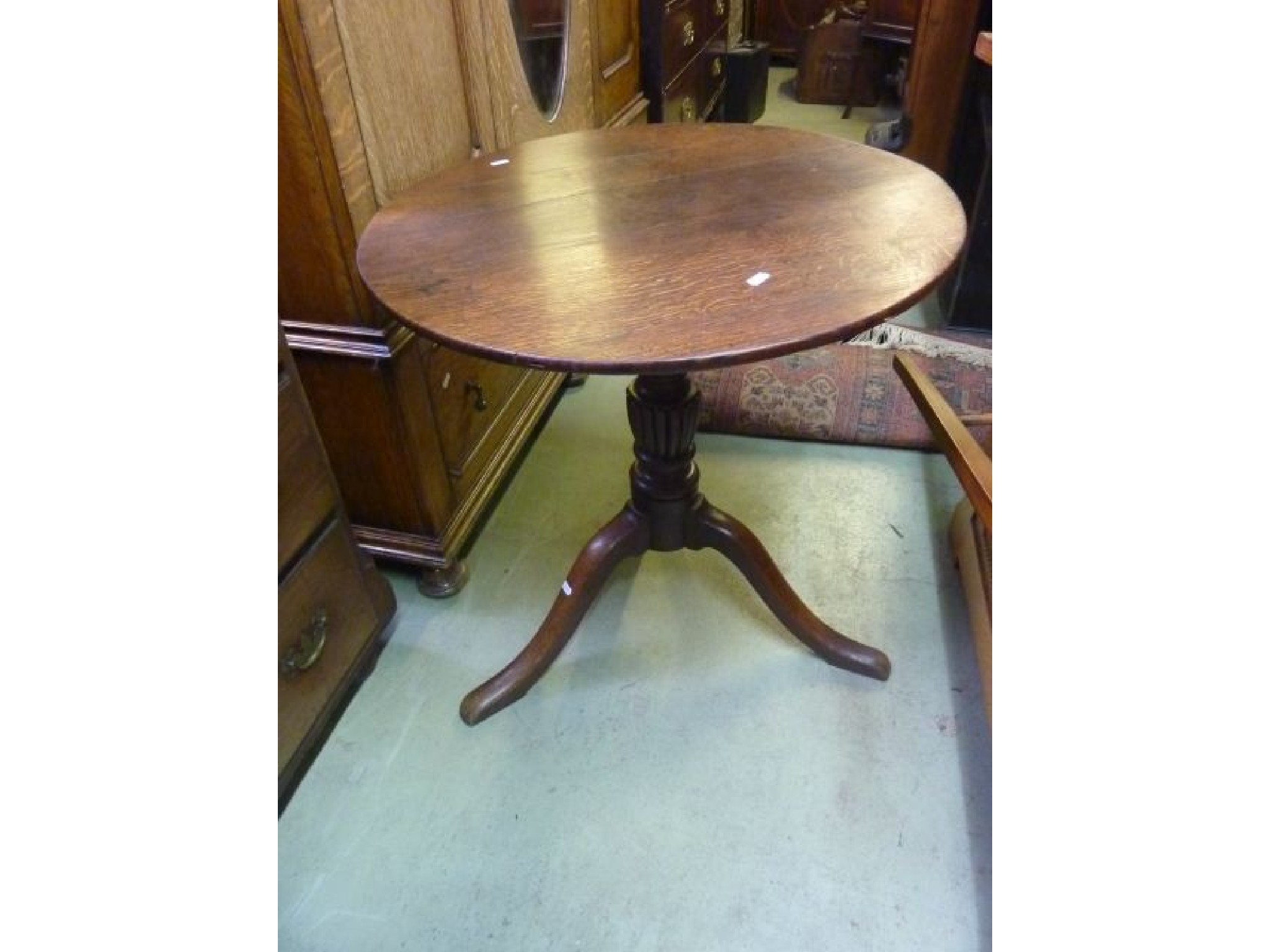 Appraisal: A Georgian oak occasional table with circular top raised on