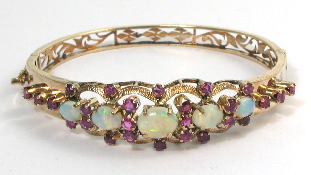 Appraisal: OPAL RUBY AND YELLOW GOLD BANGLE k yellow gold set