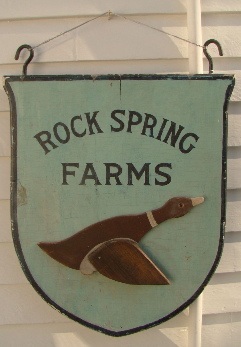 Appraisal: PAINTED WOODEN DOUBLE-SIDED SHIELD-FORM SIGN Rock Spring Farms on both