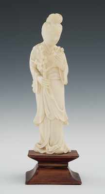 Appraisal: A Carved Ivory Quan Yin Holding Cherry Blossoms The smiling