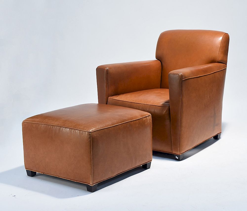 Appraisal: Leather club chair with matching ottoman Leather club chair with