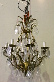 Appraisal: A thirteen light cast brass and crystal chandelier with bevelled