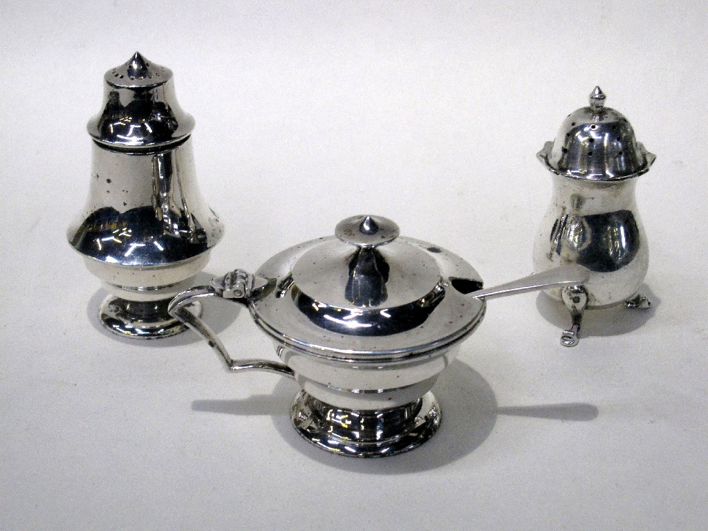 Appraisal: Lot comprising silver mustard pot and two silver peppers Birmingham