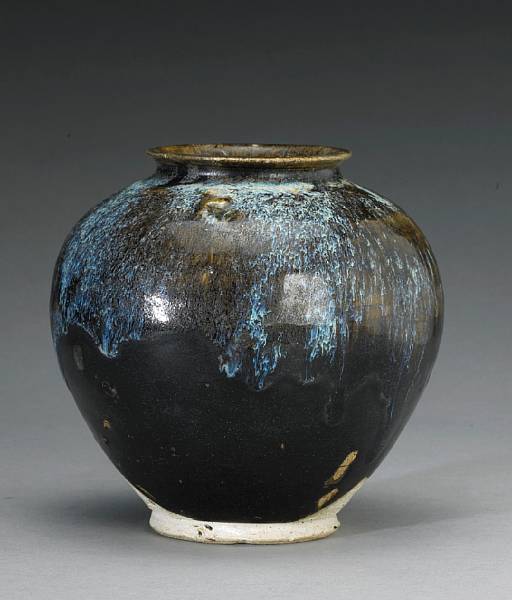 Appraisal: A small brown glazed jar with phosphatic splashes Tang Dynasty