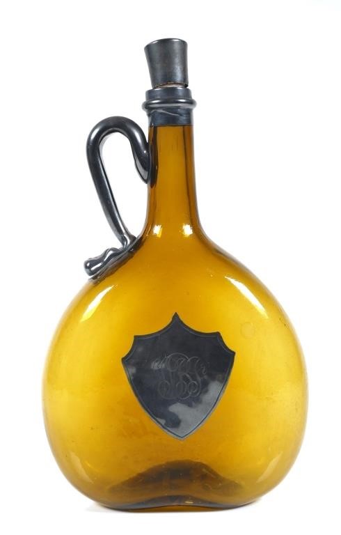 Appraisal: Circa to 's hand blown amber glass bottle Oval shaped