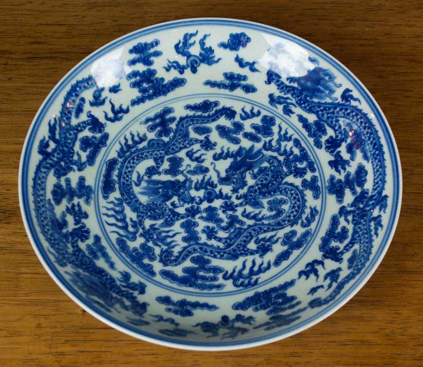 Appraisal: CHINESE QING BLUE AND WHITE PLATE featuring dragon chasing the