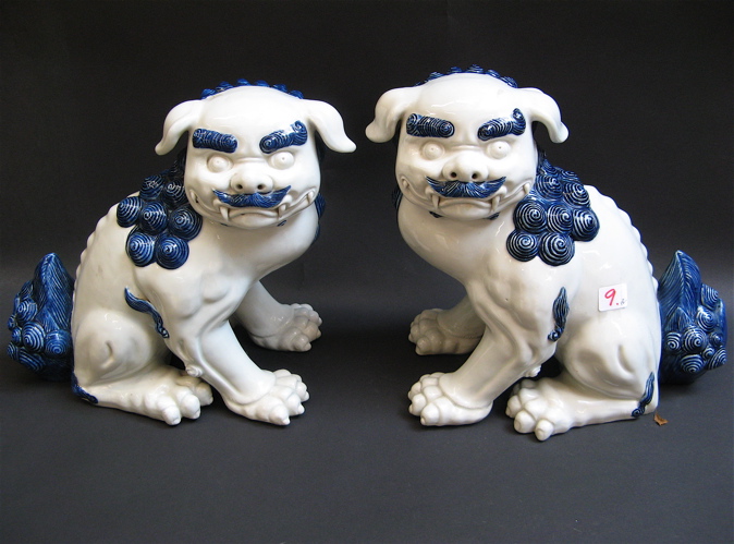 Appraisal: PAIR OF CHINESE POTTERY FOO LIONS blue accents on white