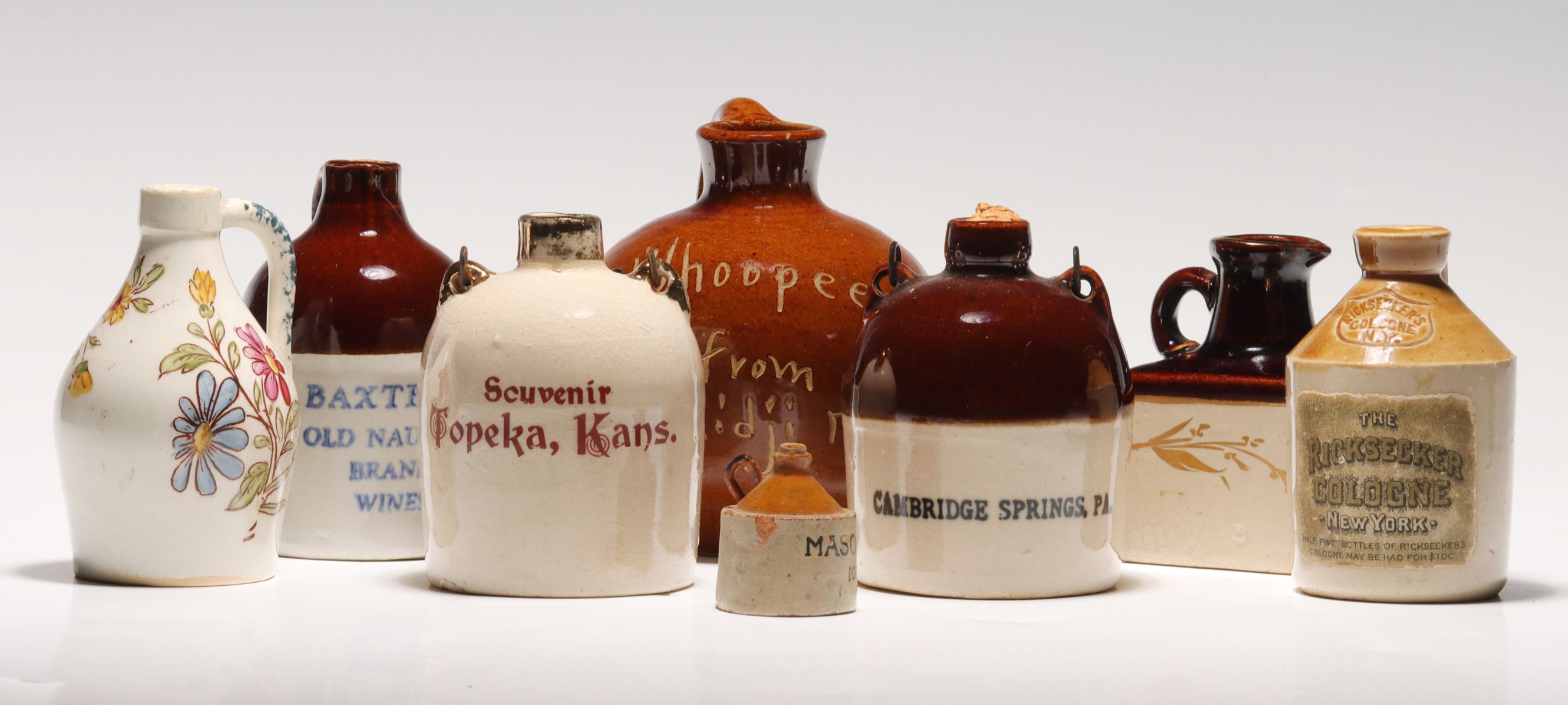 Appraisal: A COLLECTION OF SOUVENIR STONEWARE MINI JUGSEight mini jugs as