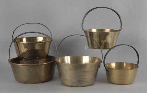 Appraisal: Five brass pots with fixed iron handles