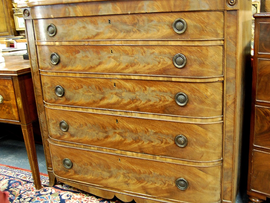 Appraisal: A George III flame mahogany chest of five long graduated