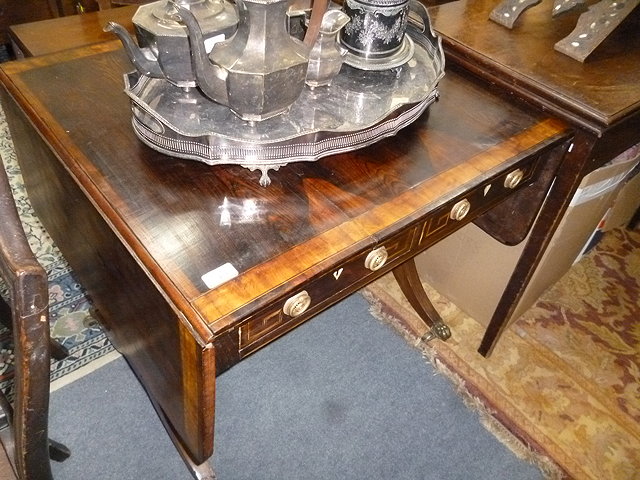 Appraisal: A REGENCY ROSEWOOD AND CROSSBANDED SOFA TABLE with drop flaps