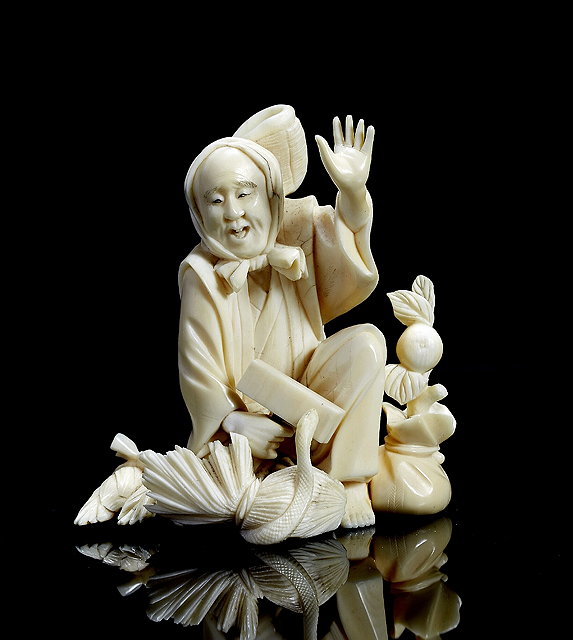 Appraisal: A Japanese ivory okimono th th Centurya gardener kneeling amidst