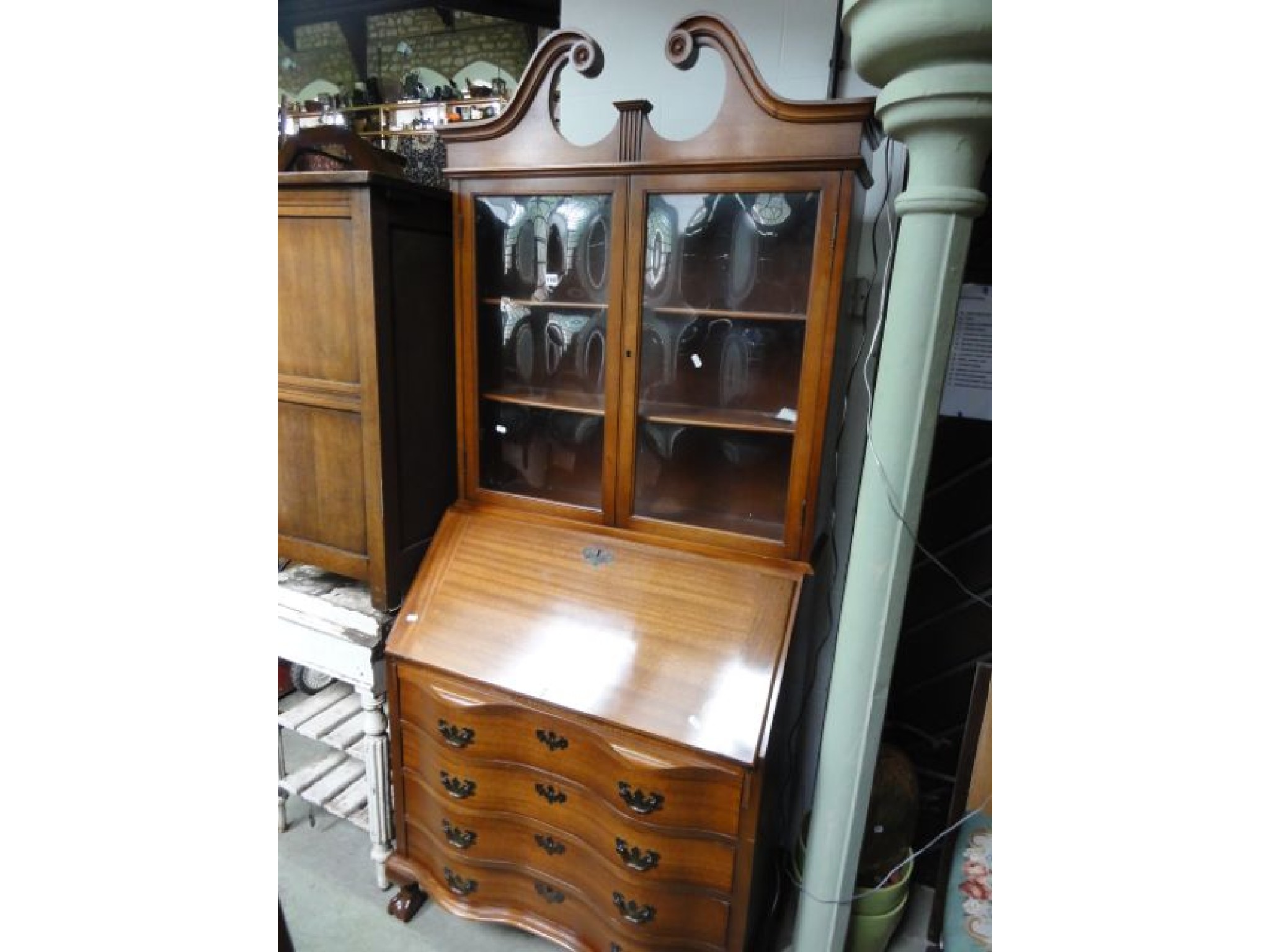 Appraisal: A Chippendale style reproduction mahogany bureau bookcase the upper section