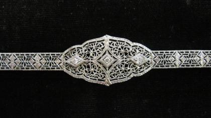 Appraisal: karat white gold and diamond filigree braceletCentral panel displays three