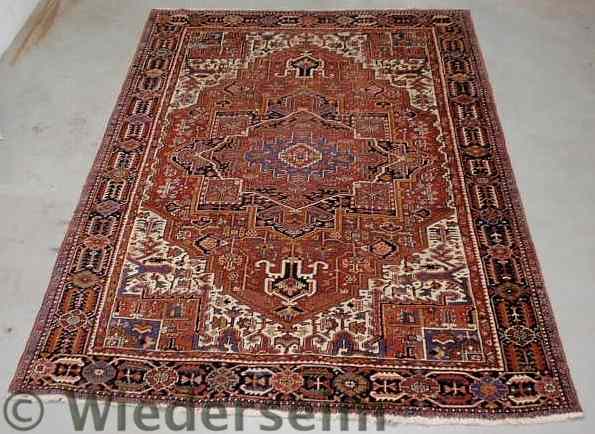 Appraisal: Room size Heriz oriental carpet red field center medallion and