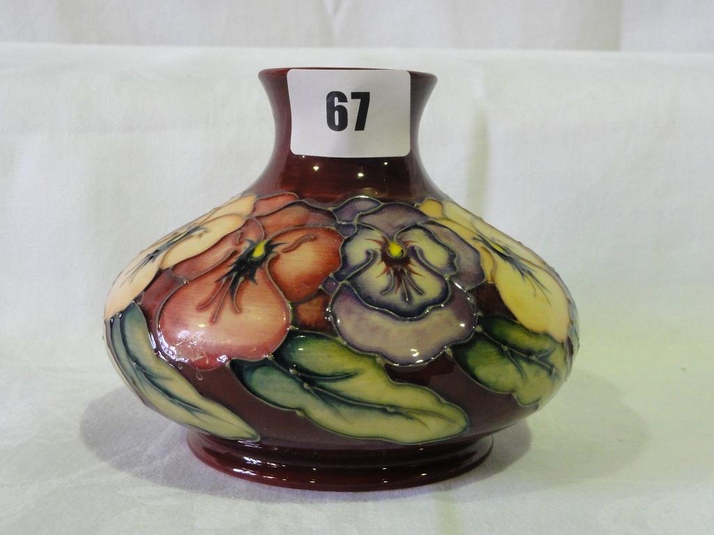 Appraisal: A dark red ground Moorcroft pottery vase of squat circular