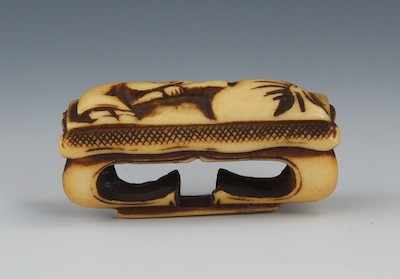 Appraisal: A Carved Staghorn Netsuke of a Pillow Edo Period Elongated