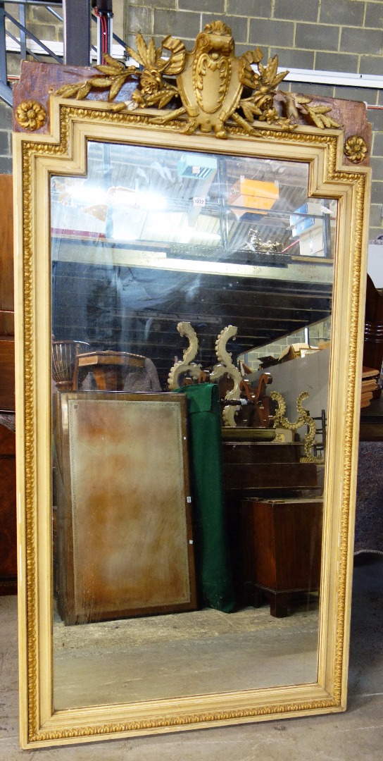 Appraisal: A late th century parcel gilt cream painted wall mirror