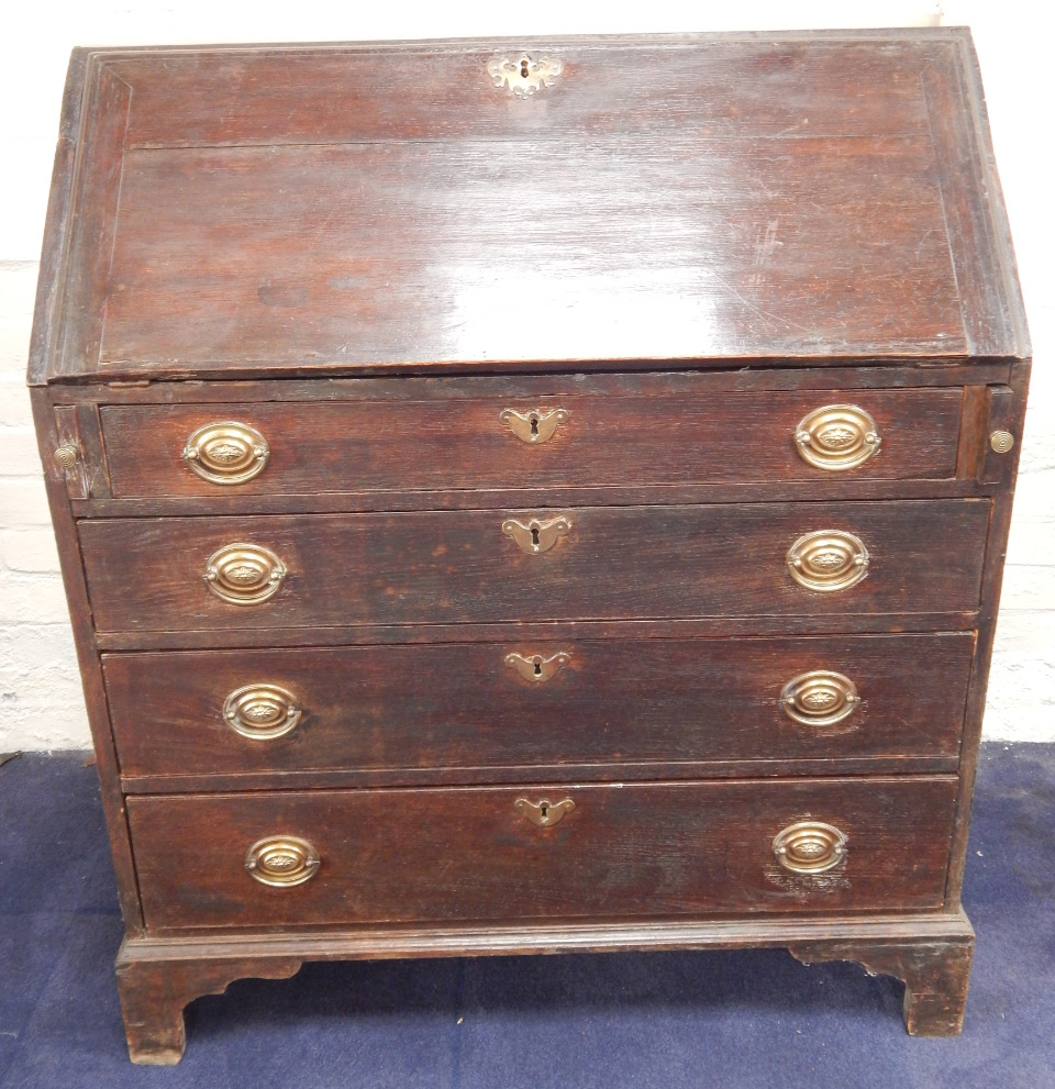 Appraisal: A thC oak bureau with fitted interior having central cupboard