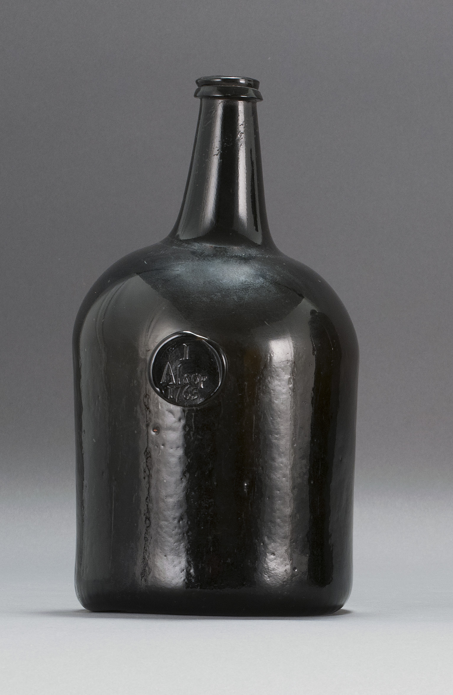 Appraisal: FREE-BLOWN GLASS LIQUOR BOTTLE Probably Continental th CenturyIn deep olive