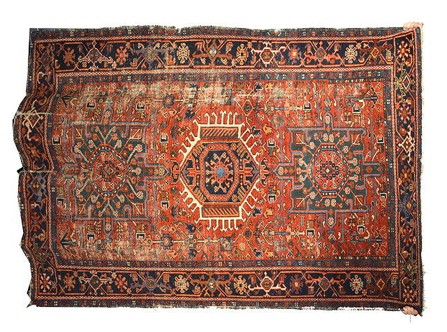 Appraisal: AN OLD KARADJA BRICK GROUND RUG with three stylised motifs